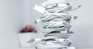 A pile of white phone charger wires