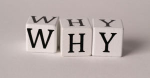 three lettered dice spelling 'why'