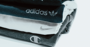 A neatly folded stack of branded t shirts