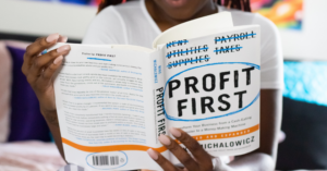 person reading profit first book