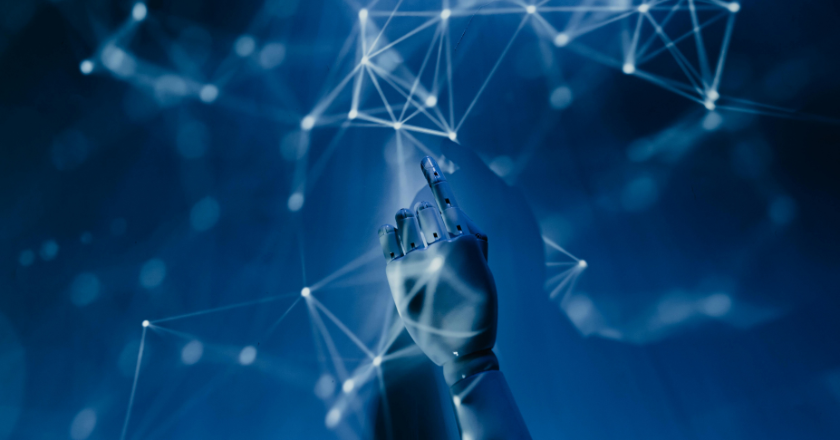 Robot hand making virtual connections on a futuristic dark blue background - used to illustrate the topic of LLM engine optimisation discussed in this blog post